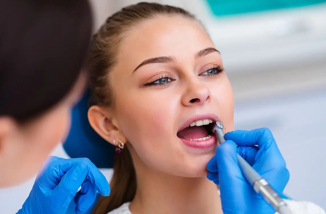 Dental professional performing scaling and root planing for periodontal deep cleaning in Flower Mound, TX